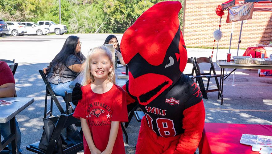 Red mascot with child