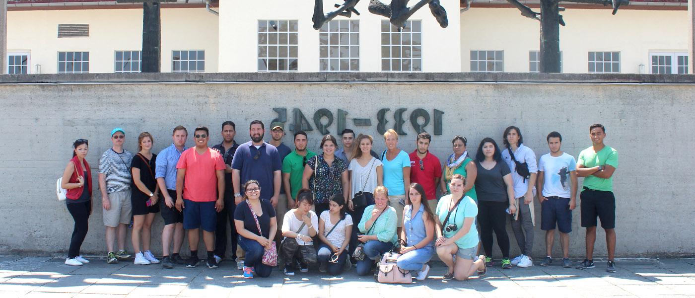 Group photo of political science students on a class trip to the World War 2 memorial in Dachau, Germany